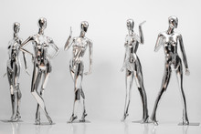 Many Fashion Shiny Female Mannequins For Clothes. Metallic Manne