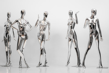 many fashion shiny female mannequins for clothes. Metallic manne