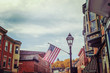 Shops along main street, Galena, Illinois, focus on flag, toned