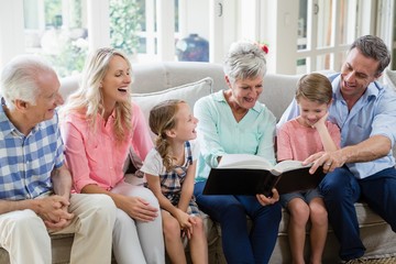 Multi-generation looking at their album photo 