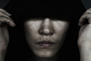 depress woman in hood with tear