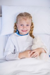 Sticker - Sick girl with teddy bear in hospital bed