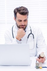 Wall Mural - Male doctor checking medicine