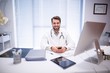 © WavebreakMediaMicro - Portrait of male doctor sitting at desk