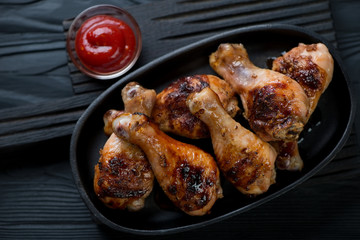 Poster - Above view of a frying pan with bbq chicken legs, close-up