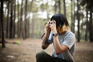 Wall Mural - Asian Photographer Taking Pictures Outdoors Concept