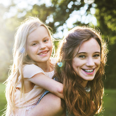 Canvas Print - Sister Togetherness Outdoors Piggyback Concept