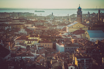 Wall Mural - Aerial view of Venice, Italy, at sunset with rooftops of buildings and vintage colors in winter sunset.