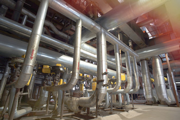 Equipment, cables and piping as found inside of a modern industr