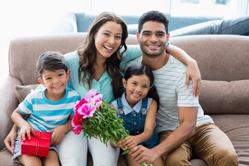 Sticker - Portrait of parents and kids sitting on sofa 