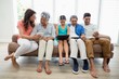 © WavebreakMediaMicro - Multi-generation family using digital tablet in living room