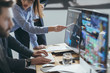 © LUMINA IMAGES - Group of brokers analysing stock martek perfprmance on their mon