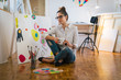 © cherryandbees - Bringing her creativity to life. Woman painting in her art studio