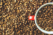 Coffee cup in coffee beans