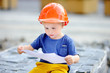 © Maria Sbytova - Little builder reading construction drawing