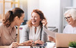 © zinkevych - Laughing businesswomen sharing ideas at work