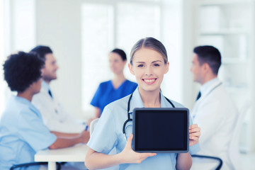 Poster - happy doctor over group of medics at hospital