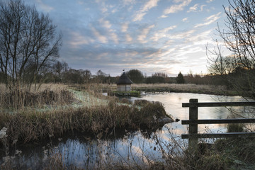 beautiful landscape on frosty winter morning of eel traps over f