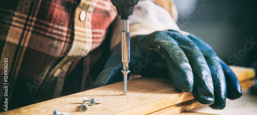 Fotomural Carpenter working with an electric screwdriver