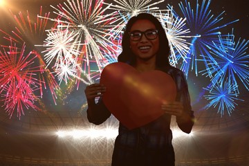 Wall Mural - Composite image of asian woman holding paper heart