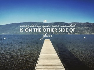 Inspirational quote on lake with pier