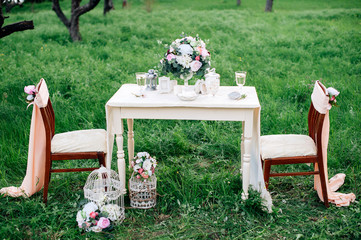 decorated table served for two in the garden. Romantic dating