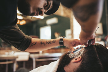 Wall Mural - Barber shaving bearded man