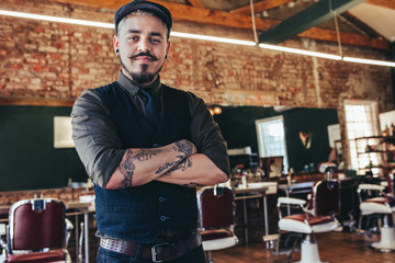 Wall Mural - Handsome young man standing at barber shop