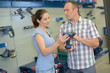 Man and woman purchasing power tool