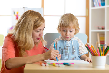 Wall Mural - Mother playing with her child son, drawing together