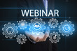 © NaMong Productions - Businessman hand holding wording webinar. sign on virtual screen. business concept.