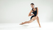 © Aikis - Young beautiful slim girl with hair braid doing dance or pilates exercise on white studio background