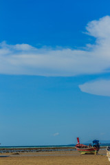 Fishing boats parking on the beach with blue sky background in t