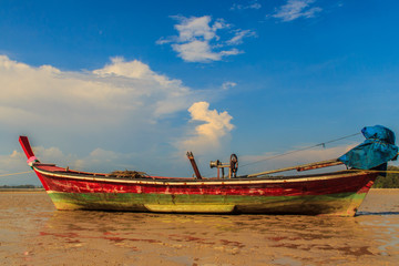 Fishing boats parking on the beach with blue sky background in t