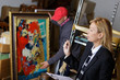 man buying painting during auction sales