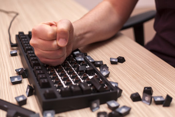 Man smashes a mechanical computer keyboard in rage using one fist