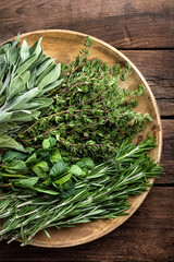 Sticker - various fresh herbs, rosemary, thyme, mint and sage on wooden background