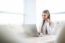 Woman Customer Support Operator With Headset And Smiling