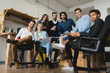 © ADDICTIVE STOCK - Portrait of business people sitting together in the office