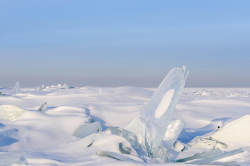 Wall Mural - blocks of ice gleaming in the sun, snow, frost, frozen water surface.