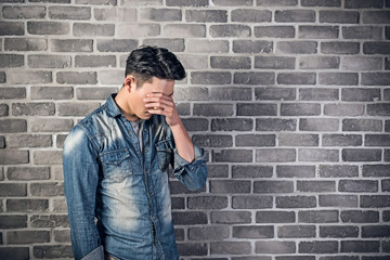 Wall Mural - sad Asian young man