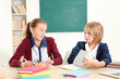 © Africa Studio - Two cute girls sitting at desk in school class