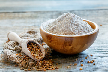 Wheat wholemeal flour in a wooden bowl.