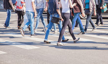 Pedestrians Walking On A Crosswalk