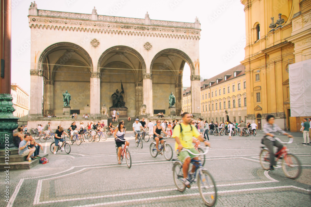 Cyclists on Odeonsplatz square in Munich, Germany - obrazy, fototapety, plakaty 