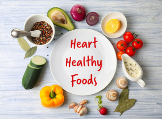 Diet for healthy heart concept. Food and plate on wooden background