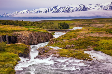 the creek flows among the flat tundra