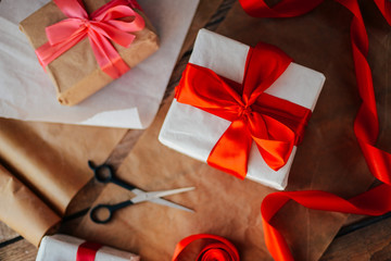 Valentine's Day concept. Gift with red bow  on the wooden backgr