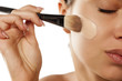 © vladimirfloyd - A young woman applied liquid foundation on her face with a brush