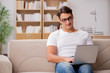 © Elnur - Man working sitting in couch sofa